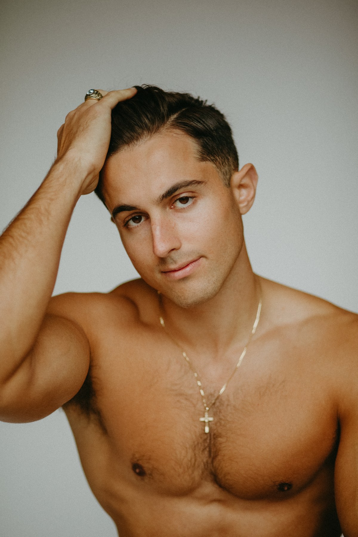 Color editorial portrait of Jacob with his hand in his hair
