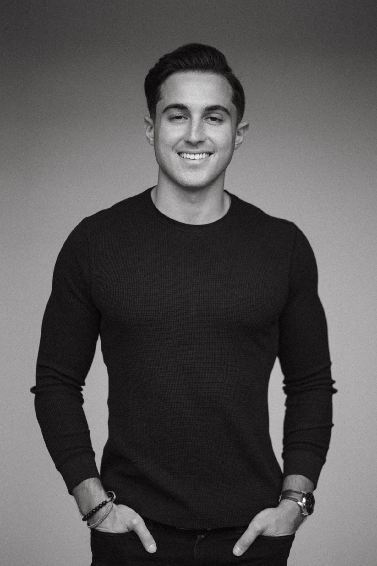Black and white studio portrait of Jacob in a black sweater